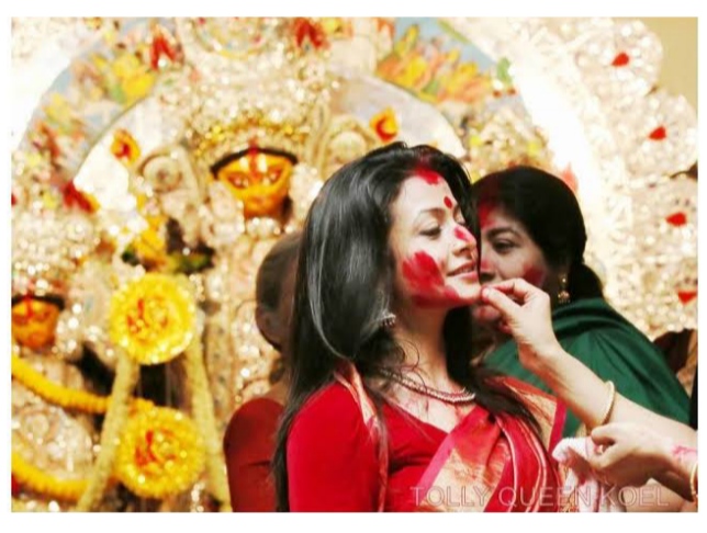 Koel Mallick in a traditional white saree with a red border at the Mallik Bari Sindoor Khela during Vijayadashami 2026.